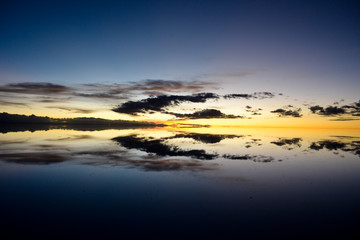 Sunrise or sunset in Uyuni salt flat (Bolivia) the biggest salar in the world covered with water...