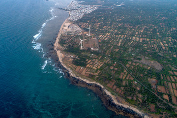 Aerial view of landscape with Turbine Green Energy Electricity, Windmill for electric power production, Wind turbines generating electricity  on Phu Qui island, Binh Thuan, Vietnam. 