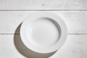 Blank clean white plate on white table