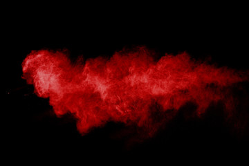 abstract red powder explosion on black background.abstract red powder splatted on black background....