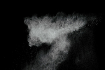 White powder explosion isolated on black background