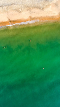Aerial view of sandy beach with tourists swimming in beautiful clear sea water, Mui Ne, Phan Thiet, Vietnam. 