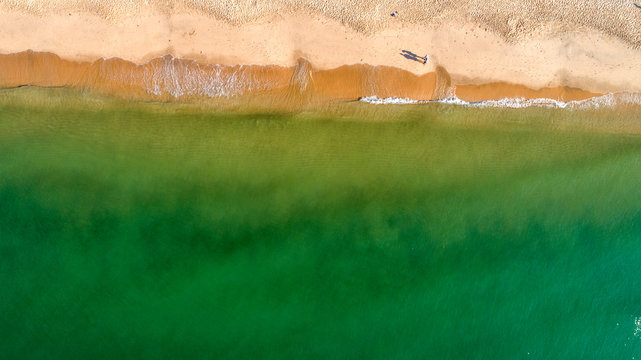 Aerial view of sandy beach with tourists swimming in beautiful clear sea water, Mui Ne, Phan Thiet, Vietnam. 