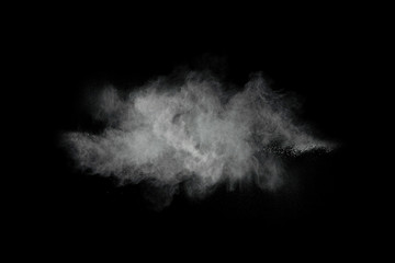 White powder explosion isolated on black background