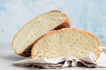 Artisan rustic bread from wheat flour on light grey stone background, selective focus. 
