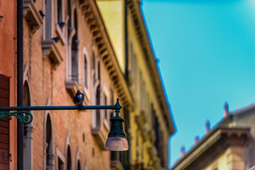 Venice, Italy - Beautiful romantic corner and balcony on Venetian streets. Antique lamp post  as decor and heritage
