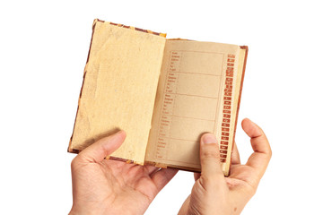 Hands holding open notebook of parchment paper