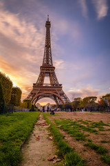 Paris, France 2017 Public park with grassy lawns and walking paths located at the foot of the Eiffel Tower during sunset