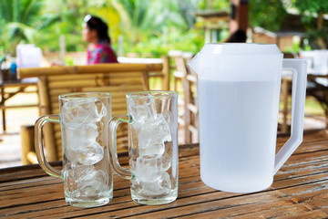 Two transparent glasses with ice in a summer cafe. Glasses with ice without water