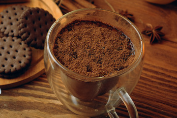 Milk cacao and cookie on the wooden table and cinnamon.