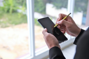 Work from home concept close up hand using mobile phone VPN to office business avoid Covid-19 Coronavirus