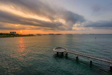 Fototapeta na wymiar Singapore 2018 Dawn at Marina Barrage over look to Pulau Ujong Breakwater