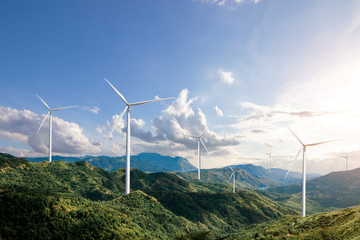 Beautiful green meadow with Wind turbines generating electricity