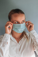 A woman in a medical mask close up