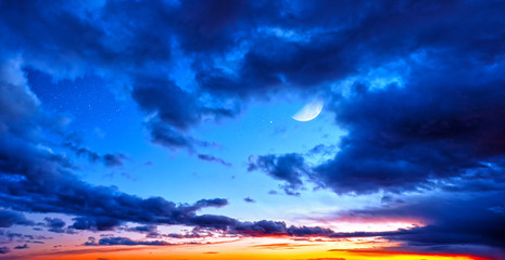 Naklejka na ściany i meble Dusk sunset sky and clouds landscape against bright star and half moon on blue universe background Wide panorama view of stars with crescent in space nature at dawn time Starry night wallpaper