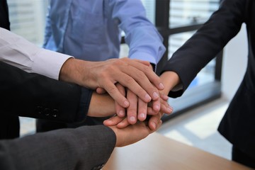 Fototapeta na wymiar Business teamwork colleague top view putting join hands together for company office project concept with selective focus