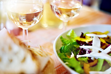 Glasses of white wine and salad