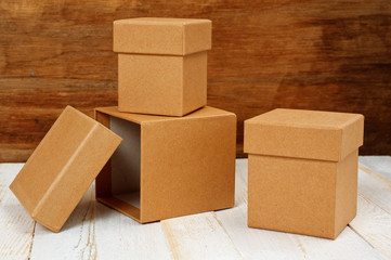 Cardboard boxes of different sizes with lids. Background for gift wrapping. Products from natural materials.