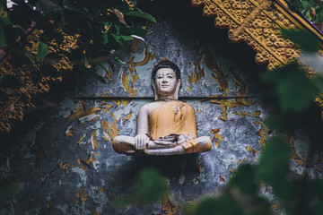 Cinematic photo of an old buddha sculpture in khmer style on an abandoned temple in Bokor Mountains...
