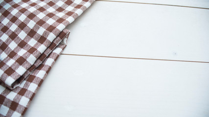 Wooden table covered with tablecloth cloth checkered