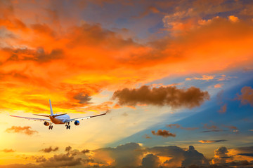 Commercial airplane flying in beautiful sky at sunset,travel concept.