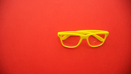 yellow glasses on a red background