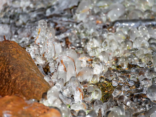 abstract picture with ice cubes embracing grass and tree roots
