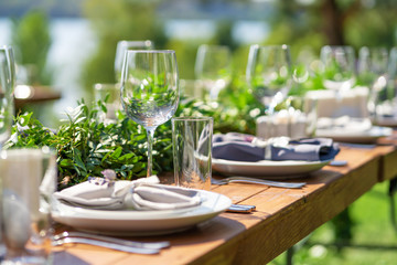 Preparing for an open-air party. Decorated with fresh flowers served tables. Table number. Decoration Details