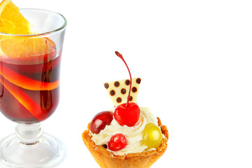 Delicious cupcakes with berries and glass with mulled wine isolated on a white background. Free space for text.