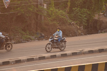 A person going on bike for purchasing essentials during lock down in india, due to covid or corona.