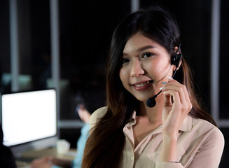 Portrait of asian call center business people working late night shift for helping assistance...