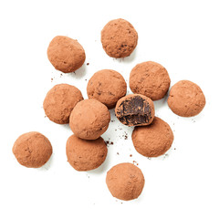 Handmade chocolate truffles covered with cocoa isolated on white background