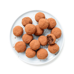 Handmade chocolate truffles covered with cocoa isolated on white background