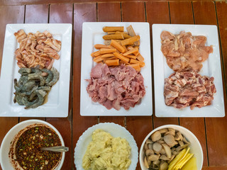 Fresh food for grilling. There are pork, chicken, shrimp, sausage, potatoes and ham with dipping...