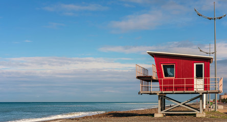 Red lifeguard rescue tower on the beach