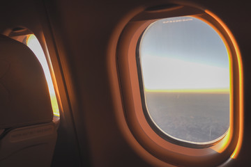 The morning sun shone through the glass on the plane to welcome tourists before arriving at the airport.