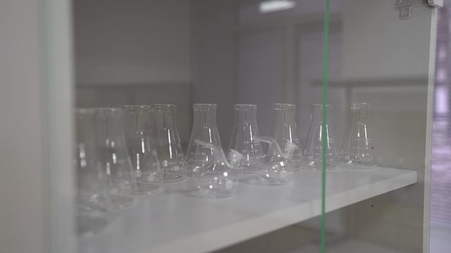 Laboratory transparent tubes empty flasks for medical tests camera movement