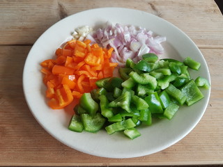 Freshly cut vegetables for soup on wooden table