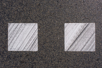 Tarmac texture. Markings painted on a tarmac road. Top view