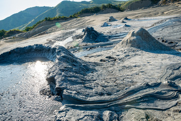 the sun set over the mud volcanoes