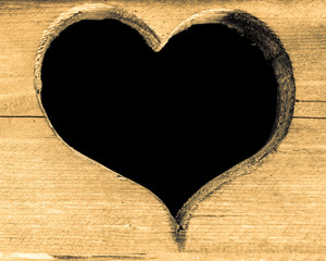 Heart carved on a wooden board.