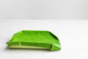 Green leaf of a banana. Eco dishes for food. Cardboard frame wrapped in a banana leaf. Eco friendly plate