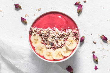 Fototapeta na wymiar Raspberries smoothie bowl with fresh banana and granola