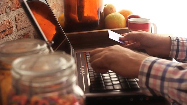 man making an online credit card payment from home