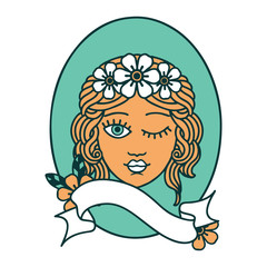 tattoo with banner of a maiden with crown of flowers winking