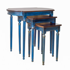 Retro wooden three nested tables with blue legs isolated on white background including clipping path