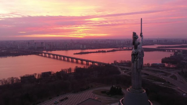 Drone video. Monument of Motherland Mother in Kiev. Ukraine. Devoted to the Wold War II. Red dawn city view. 