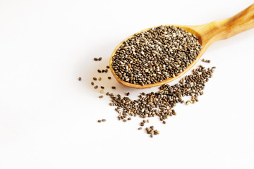 Black Chia seeds in a wooden spoon close-up. Macrophotography of Chia. Health food. Good nutrition. Nutritional Supplement.Top view.