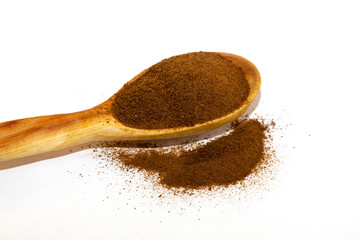 Instant chicory in a wooden spoon on a white background close-up. Isolate. Top view. Flat lay. Macro of chicory.