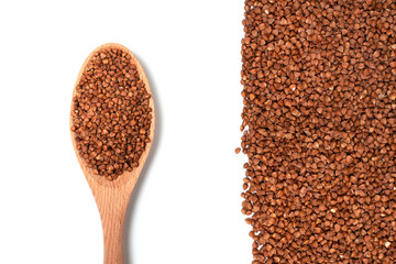 Dry buckwheat on wooden spoon isolated on white background.